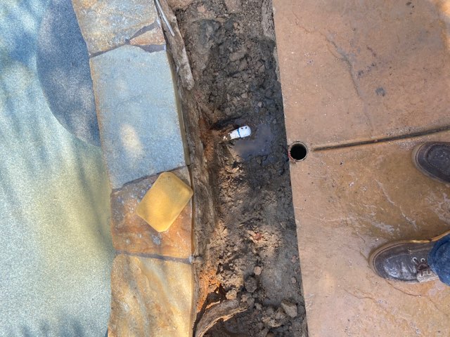 leak next to pool coping plumbing